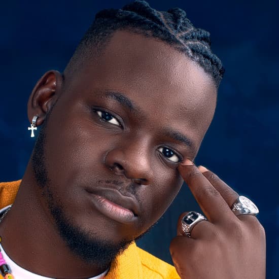 Close portrait of Day Wale against a deep blue backdrop
